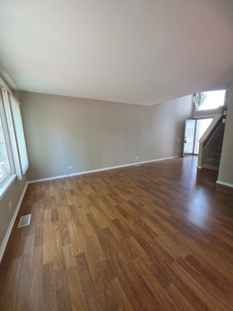 407 Spaulding Road, Unit 407 Bartlett, IL 60103 - Photo 16 of 25 a view of an empty room and wooden floor