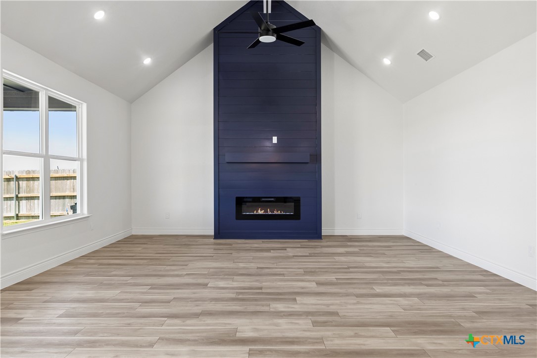 1823 Ember Drive Temple, TX 76502 - Photo 13 of 46 a view of an empty room with a fireplace and window