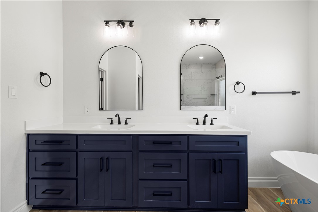 1823 Ember Drive Temple, TX 76502 - Photo 20 of 46 a bathroom with double sink and a mirror