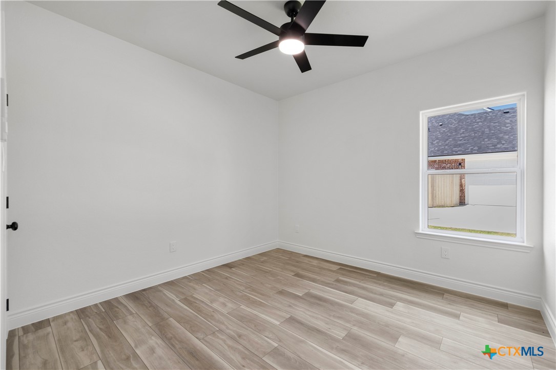 1823 Ember Drive Temple, TX 76502 - Photo 26 of 46 an empty room with a window and a ceiling fan