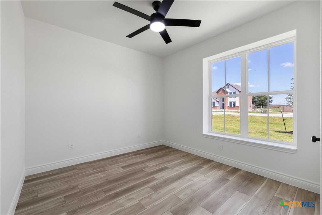 1823 Ember Drive Temple, TX 76502 - Photo 29 of 46 a view of an empty room with a window and wooden floor