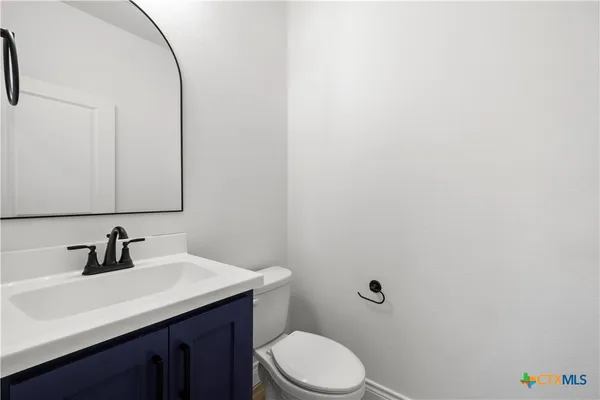 a bathroom with a sink a toilet and mirror