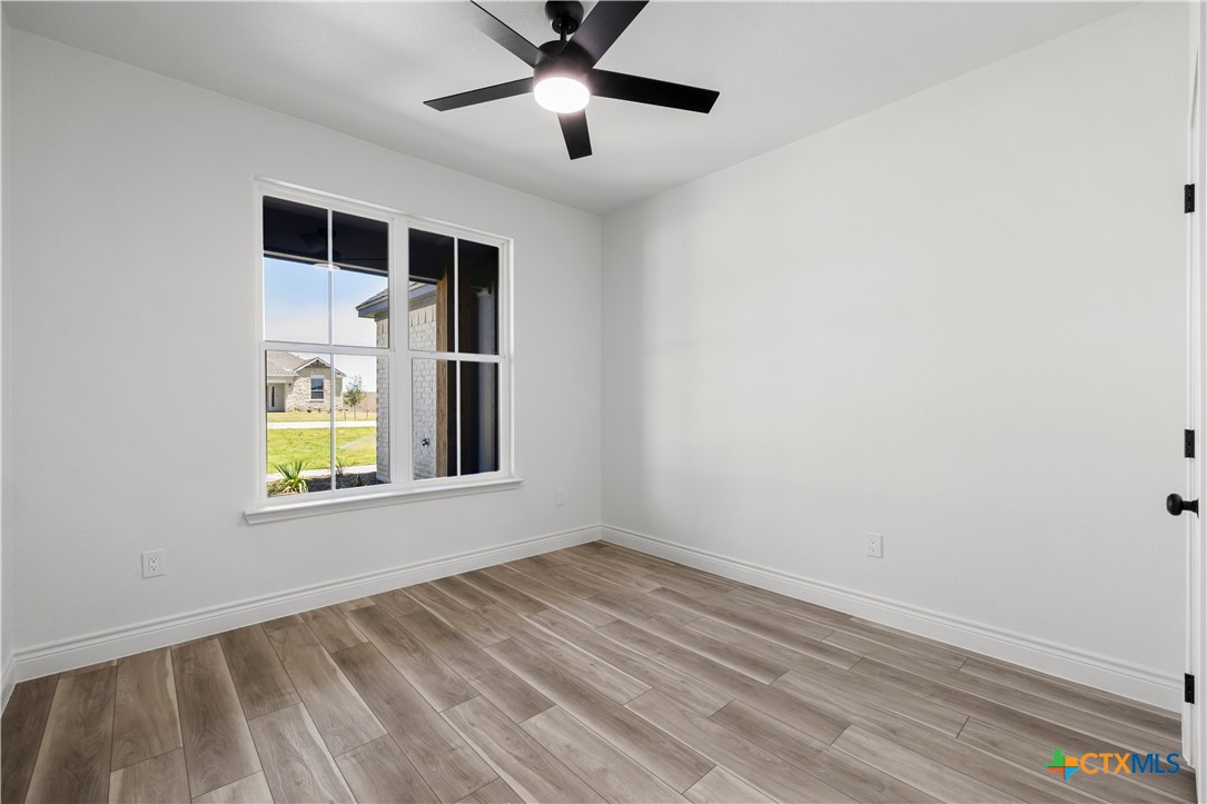 1823 Ember Drive Temple, TX 76502 - Photo 32 of 46 a view of an empty room with a window and wooden floor