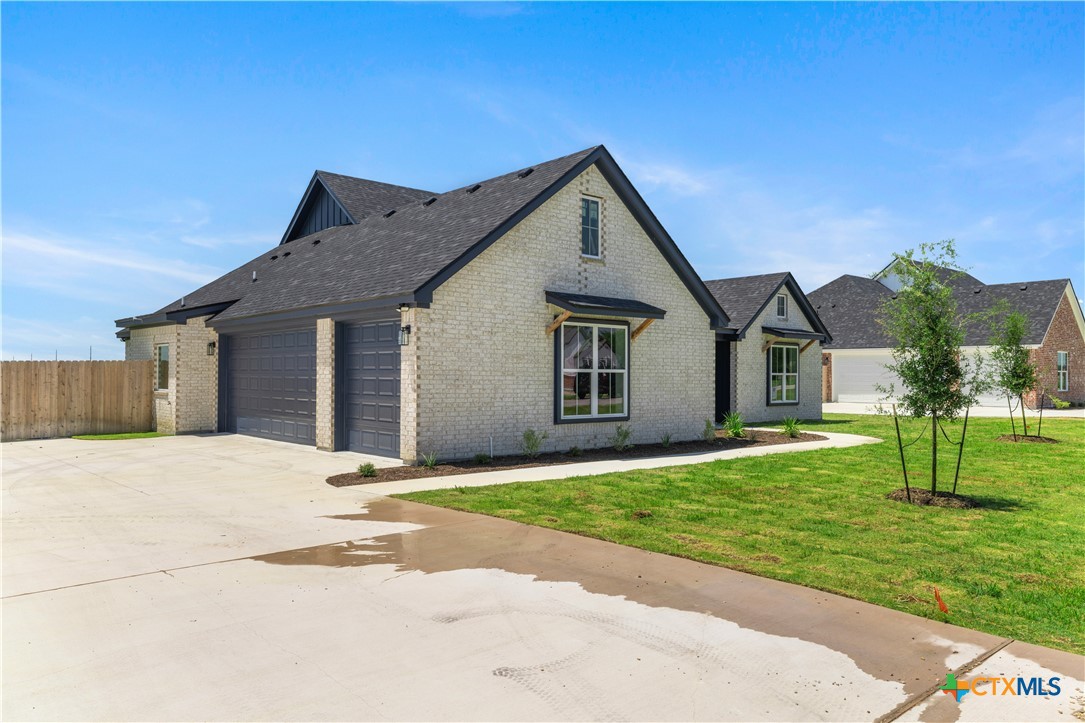 1823 Ember Drive Temple, TX 76502 - Photo 42 of 46 a front view of a house with a yard and garage