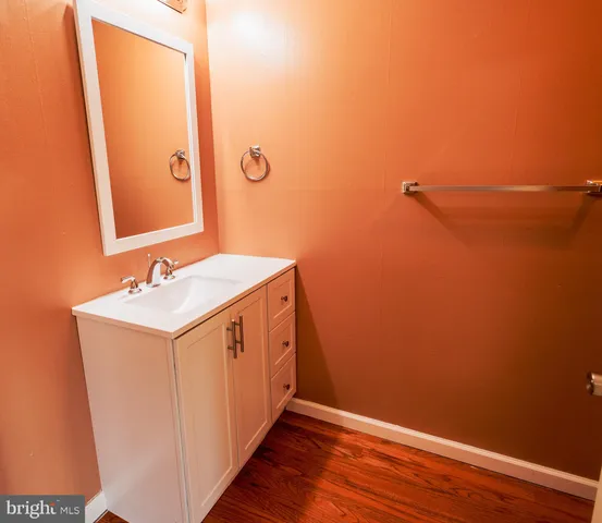 a utility room with a sink a mirror and vanity