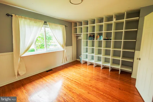 a view of a room with wooden floor and windows