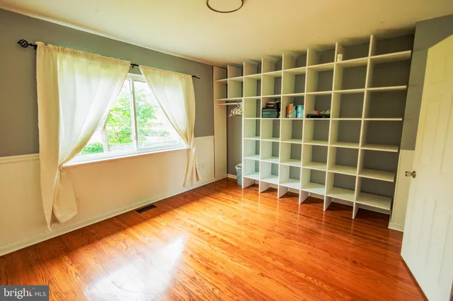 a view of a room with wooden floor and windows