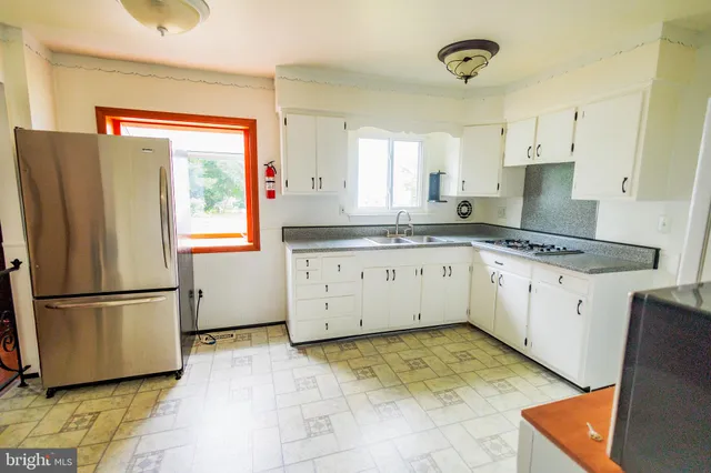 a kitchen with stainless steel appliances granite countertop a refrigerator sink and cabinets