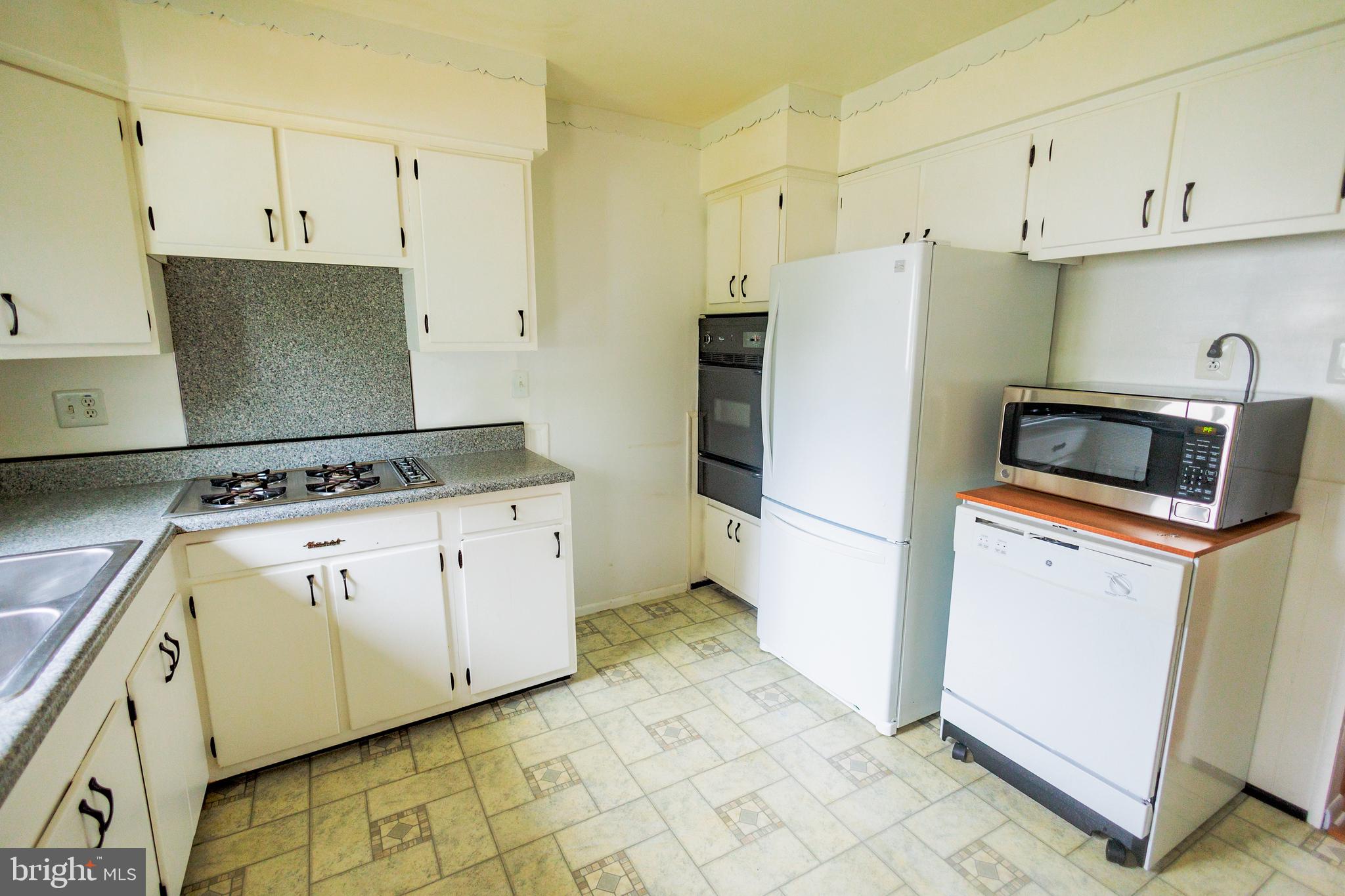 300 Macclelland Avenue Glassboro, NJ 08028 - Photo 16 of 39 a kitchen with cabinets and steel stainless steel appliances