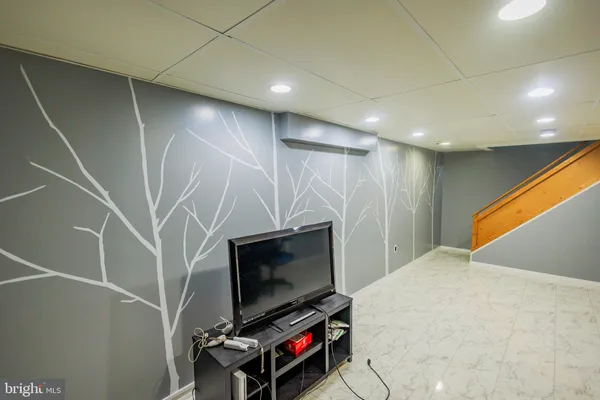 a living room with a flat screen tv and a walk in closet