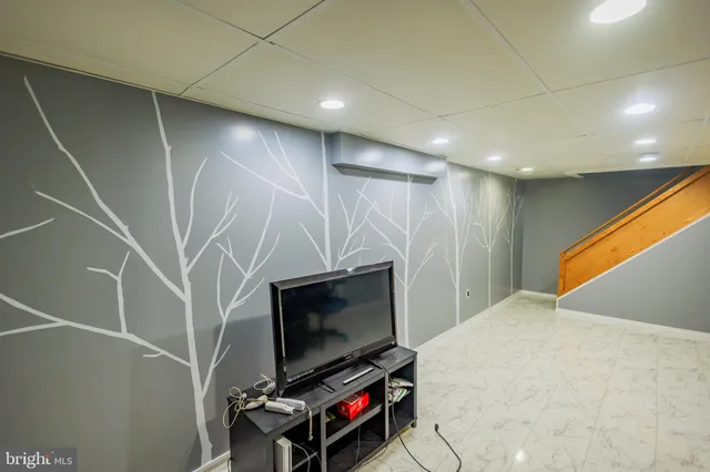 a living room with a flat screen tv and a walk in closet