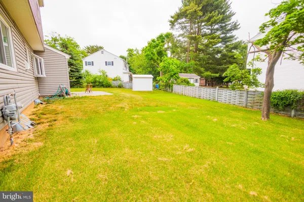 a swimming pool with trees in front of it