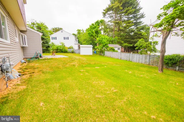 a swimming pool with trees in front of it