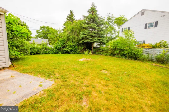 a view of an ocean with a house in the background