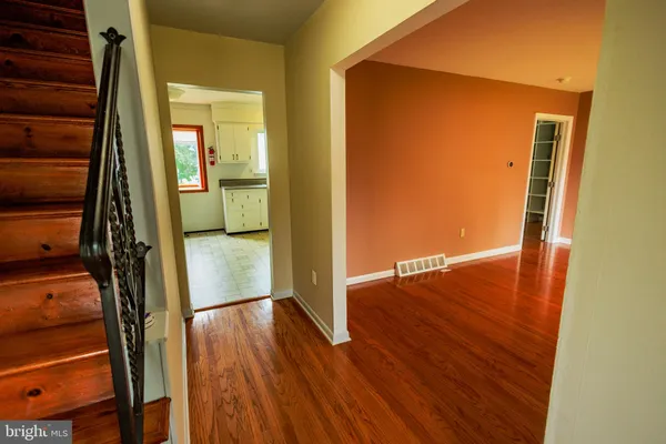 a view of a hallway with wooden floor