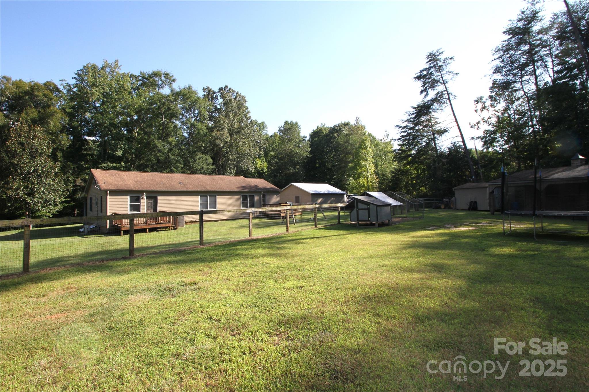3744 Hunting Country Road Tryon, NC 28782 - Photo 26 of 34 a backyard of a house with table and chairs