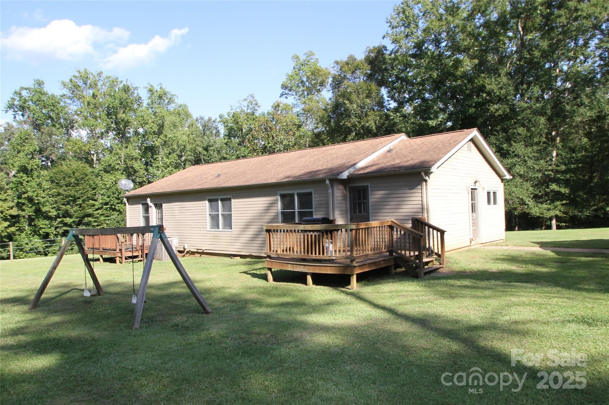 3744 Hunting Country Road Tryon, NC 28782 - Photo 5 of 34 a front view of a house with a yard table and chairs