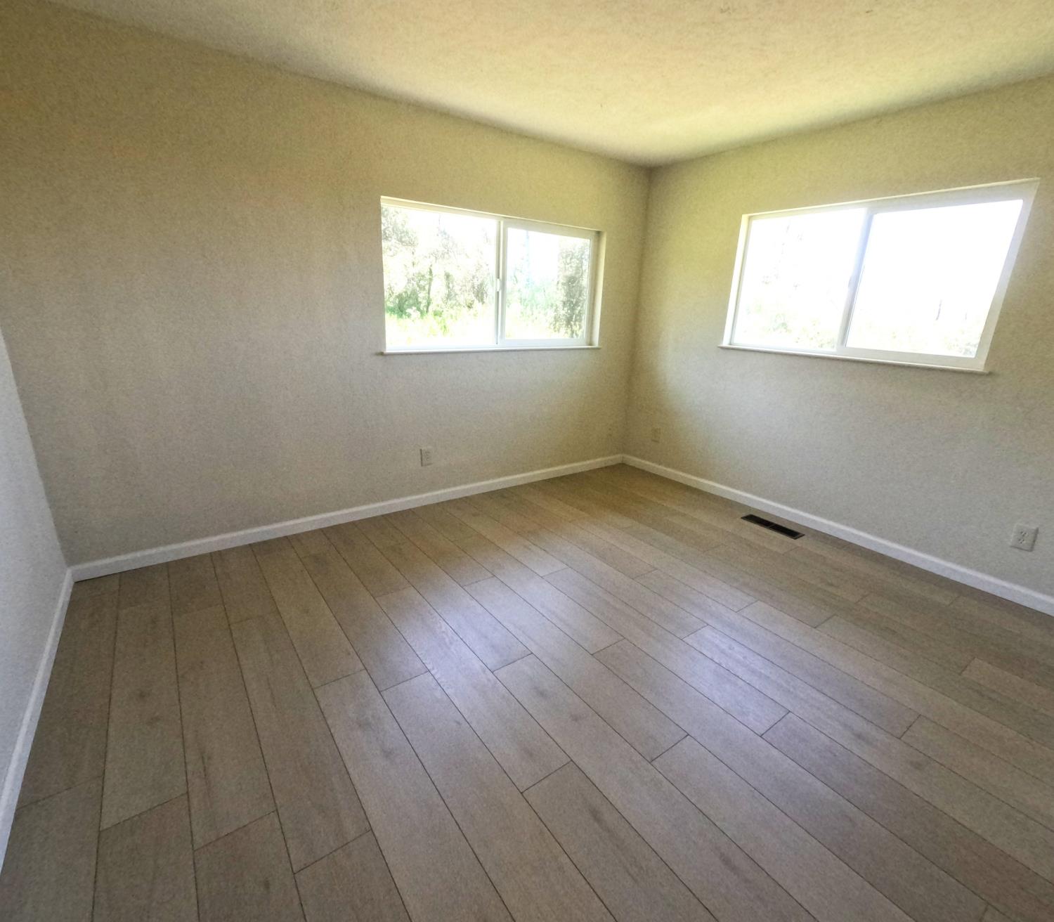 21665 Manton School Road Manton, CA 96059 - Photo 14 of 30 a view of an empty room with wooden floor and a window