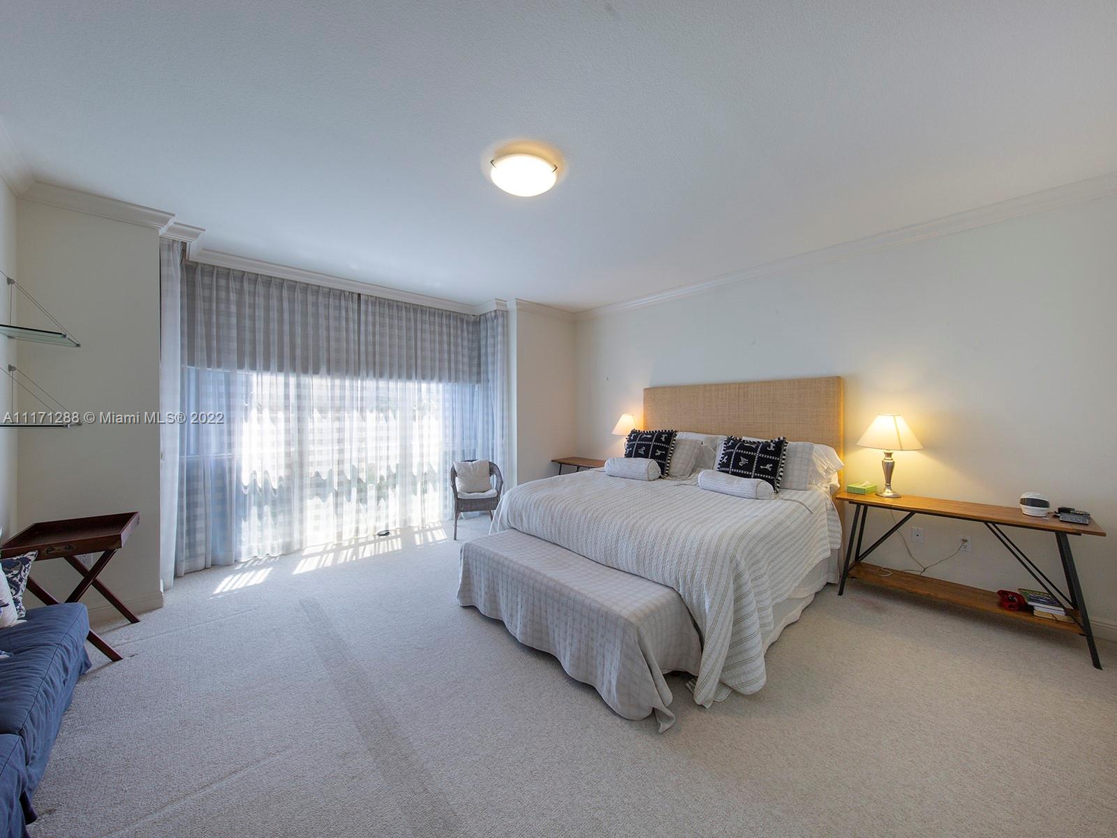 735 Crandon Boulevard, Unit 503 Key Biscayne, FL 33149 - Photo 11 of 18 a bedroom with a bed and a window