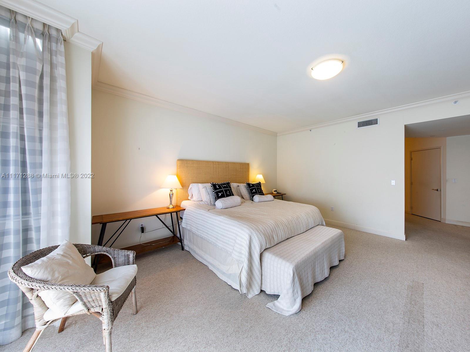 735 Crandon Boulevard, Unit 503 Key Biscayne, FL 33149 - Photo 12 of 18 a bedroom with a bed and a couch