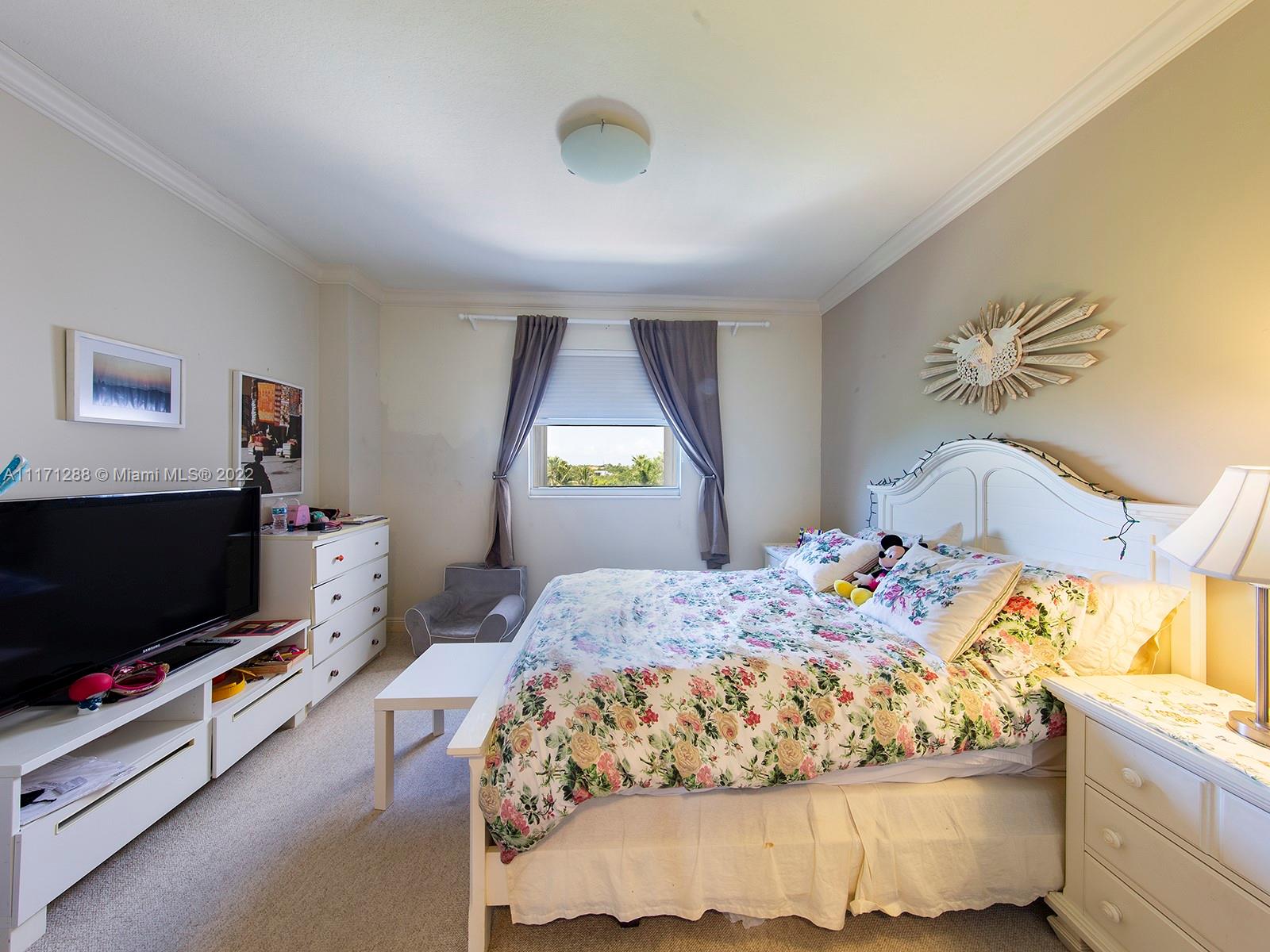 735 Crandon Boulevard, Unit 503 Key Biscayne, FL 33149 - Photo 14 of 18 a bedroom with a bed and flat screen tv