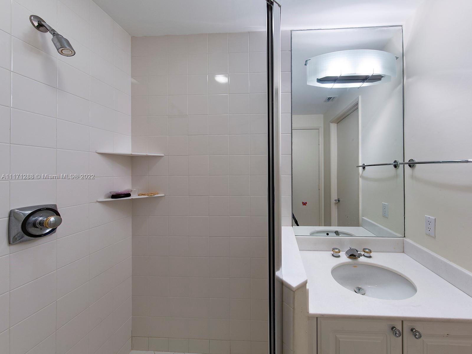 735 Crandon Boulevard, Unit 503 Key Biscayne, FL 33149 - Photo 15 of 18 a bathroom with a sink and a mirror