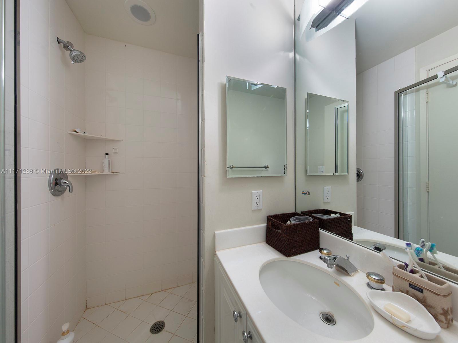 735 Crandon Boulevard, Unit 503 Key Biscayne, FL 33149 - Photo 17 of 18 a bathroom with a sink and a mirror