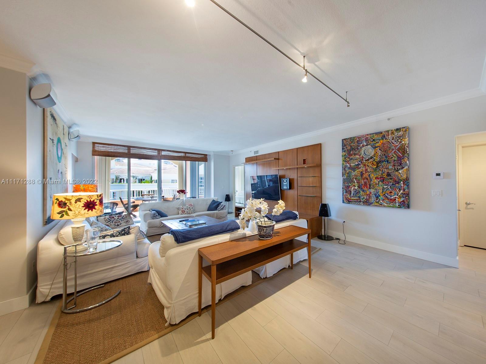 735 Crandon Boulevard, Unit 503 Key Biscayne, FL 33149 - Photo 8 of 18 a living room with furniture and a large window