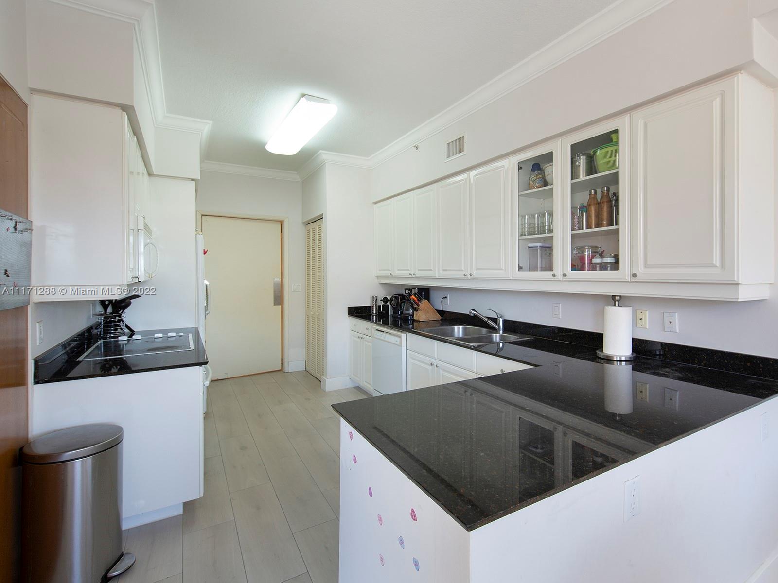 735 Crandon Boulevard, Unit 503 Key Biscayne, FL 33149 - Photo 9 of 18 a kitchen that has a sink and a stove