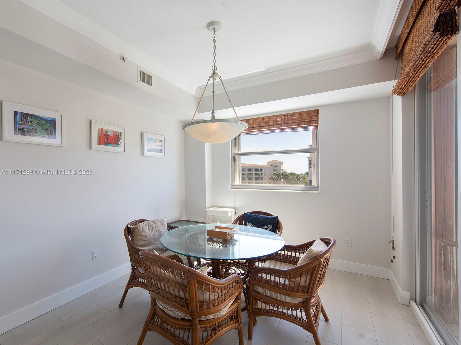 735 Crandon Boulevard, Unit 503 Key Biscayne, FL 33149 - Photo 10 of 18 a dining room with furniture and window