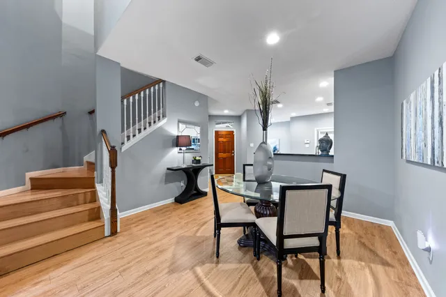 a dining room with furniture and wooden floor