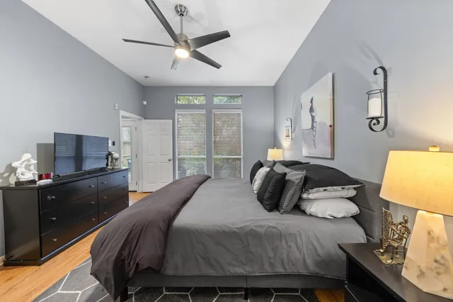a bedroom with a bed and wooden floor