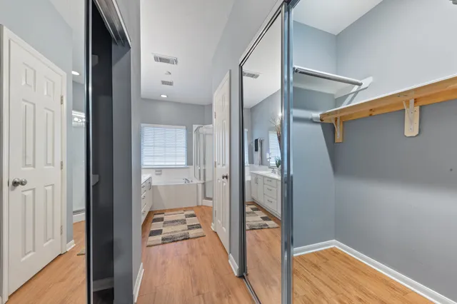 a view of a hallway with wooden floor and staircase