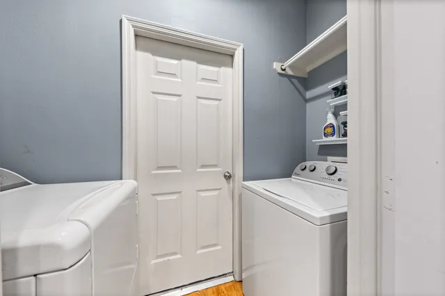 a view of a patio with table and chairs with wooden fence and plants