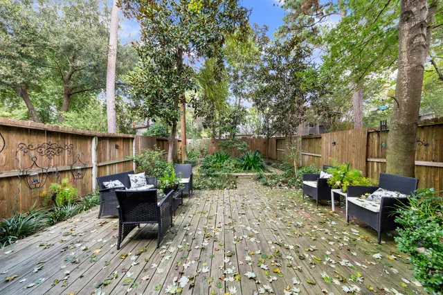 a front view of a house with yard and sitting area