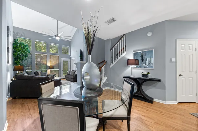 a view of a dining room with furniture and a chandelier