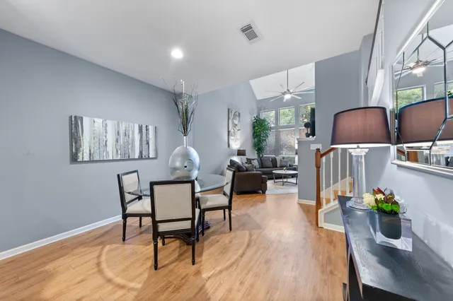 a dining room with furniture and wooden floor