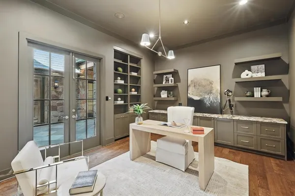 a living room with furniture a floor to ceiling window and cabinet