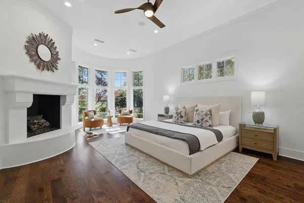 a bedroom with a large bed and a fireplace
