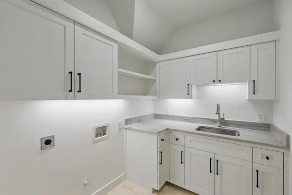 a kitchen with a sink cabinets and a window