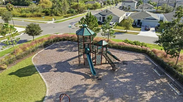 an aerial view of a house with swimming pool and outdoor seating