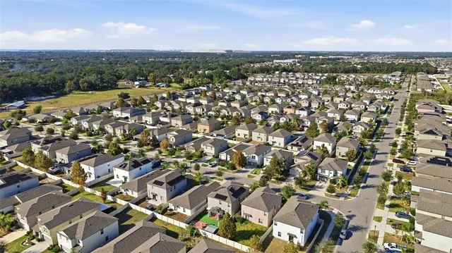 an aerial view of residential houses with outdoor space