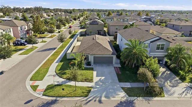 an aerial view of residential houses with outdoor space