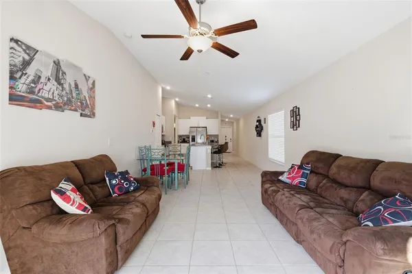 a living room with furniture and kitchen view