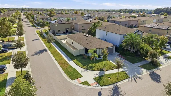 an aerial view of a house with yard swimming pool and outdoor seating
