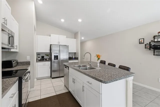 a kitchen with refrigerator and cabinets