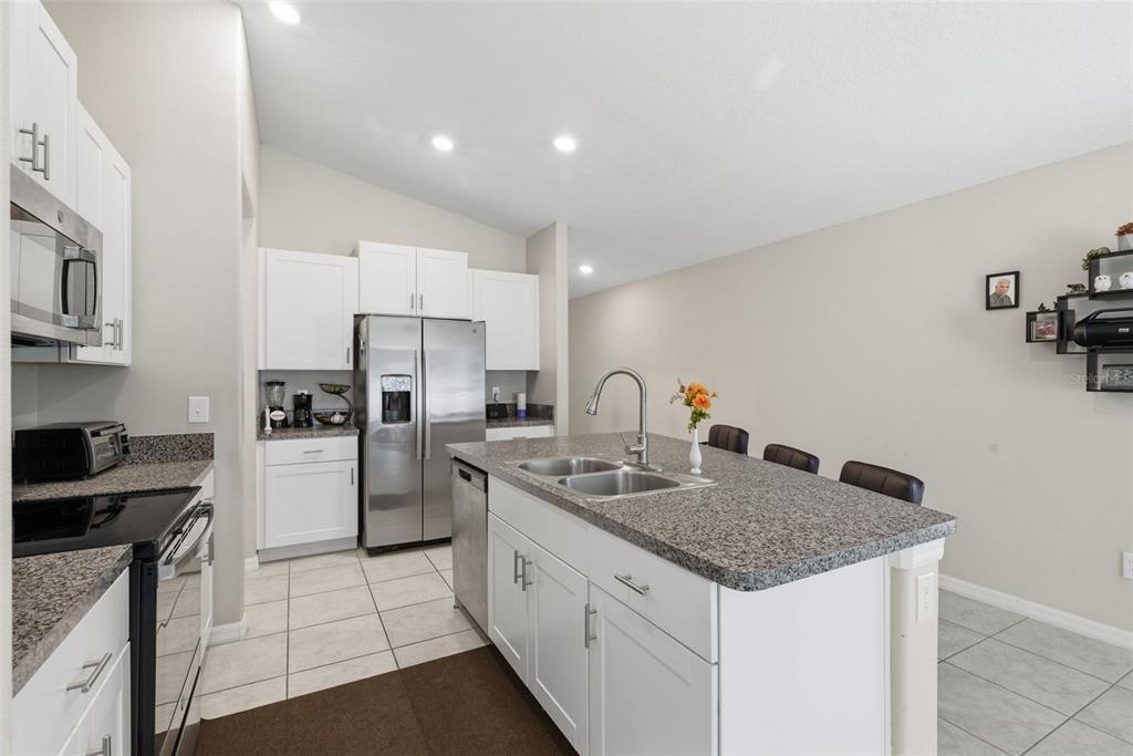 10239 Bright Crystal Avenue Riverview, FL 33578 - Photo 31 of 47 a kitchen with refrigerator and cabinets