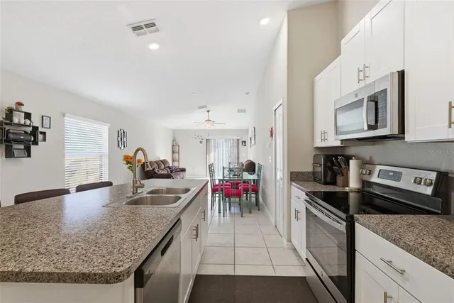 a kitchen with a stove sink and cabinets