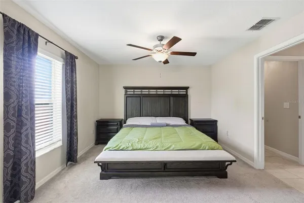 a bedroom with a bed and window
