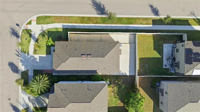 an aerial view of a house with a swimming pool